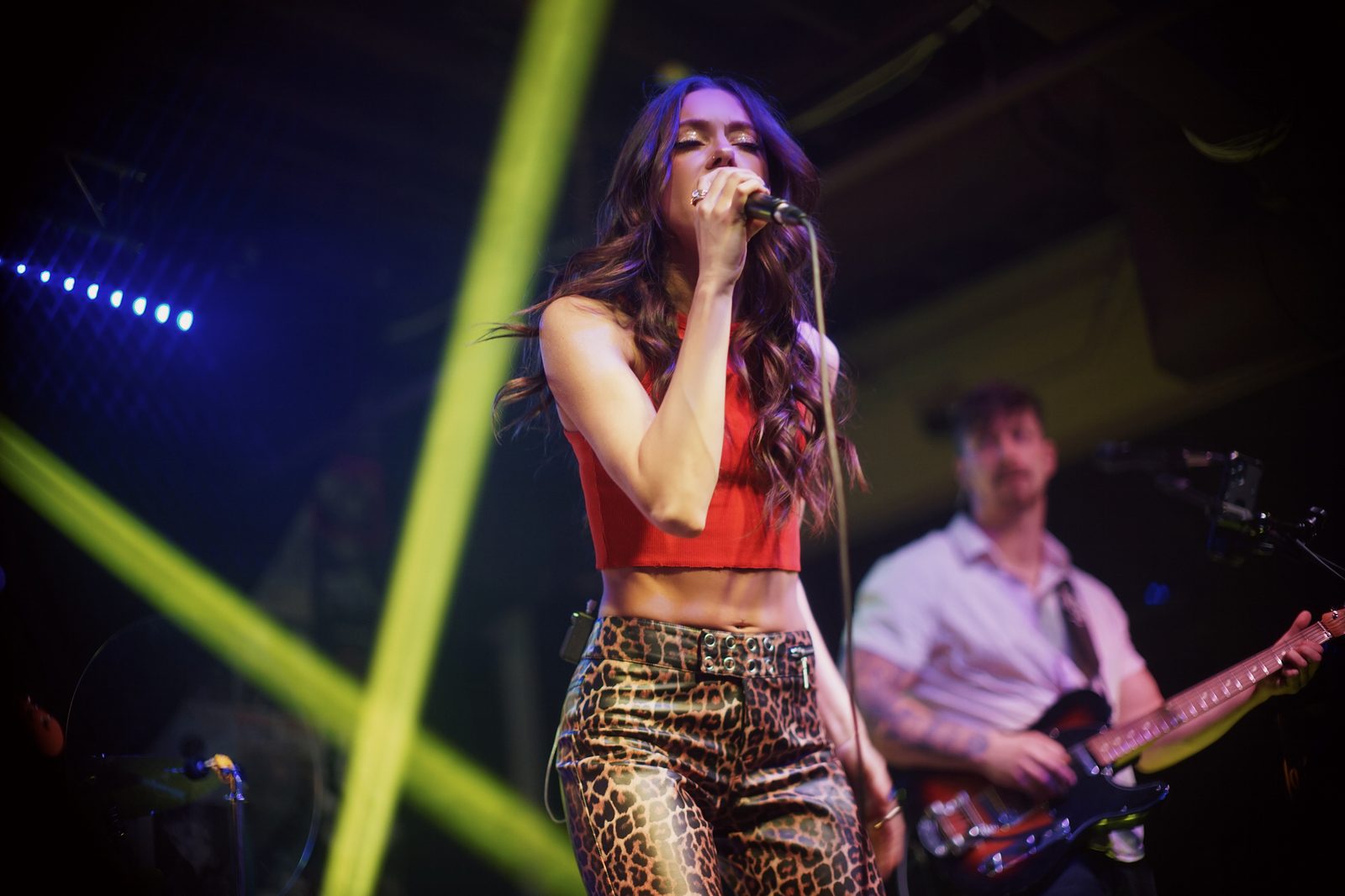 Laura Vinson singing under stage lights